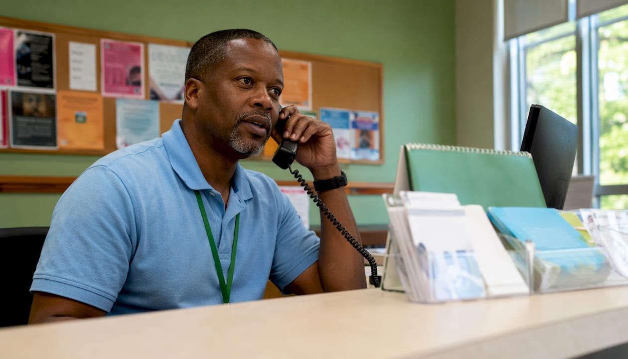 Man in community mental health center making call